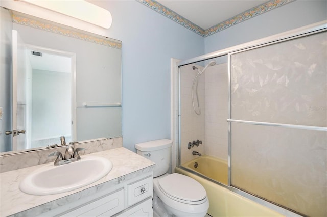 full bathroom with vanity, toilet, and combined bath / shower with glass door