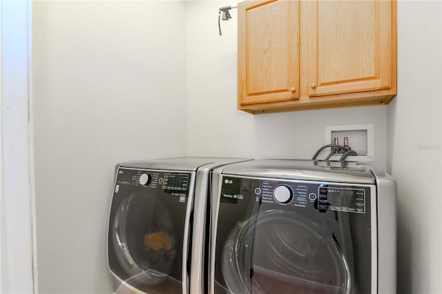 laundry area featuring cabinets and separate washer and dryer