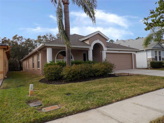 ranch-style home featuring a front lawn and a garage