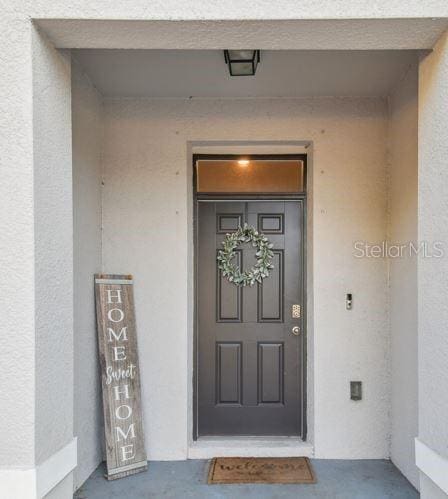 property entrance featuring stucco siding