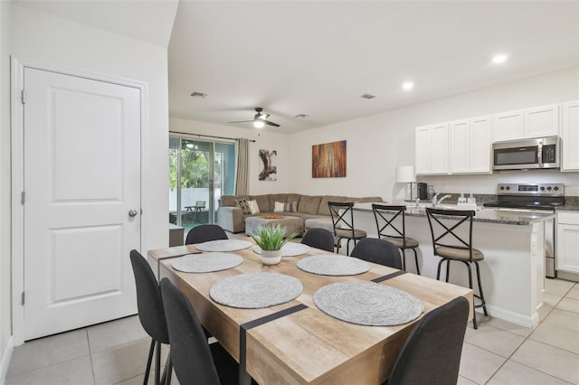 dining space with light tile patterned flooring, a ceiling fan, and recessed lighting