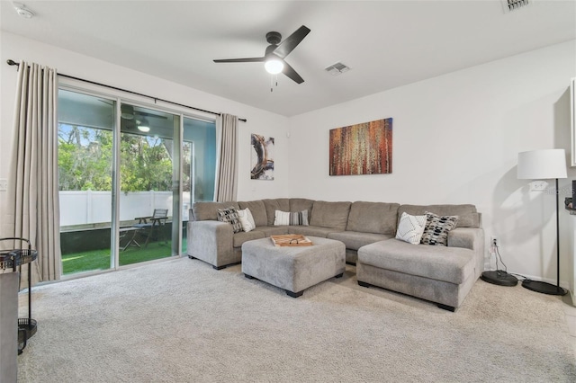 living area featuring carpet and ceiling fan