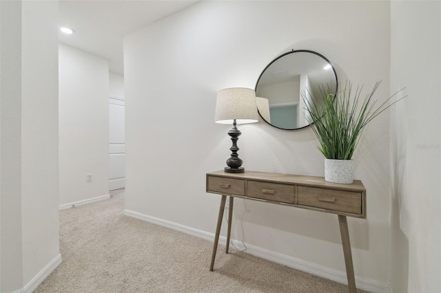 hall featuring carpet flooring and baseboards