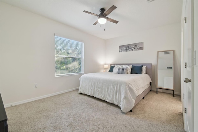 carpeted bedroom with baseboards and a ceiling fan