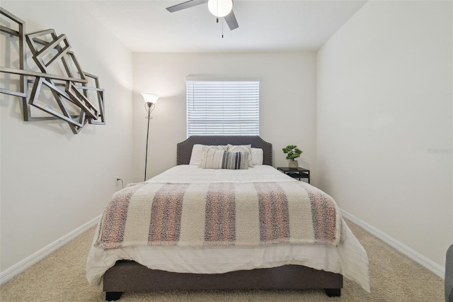 carpeted bedroom featuring baseboards and a ceiling fan
