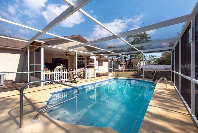 view of swimming pool featuring a fenced in pool, a patio, ceiling fan, fence, and a lanai