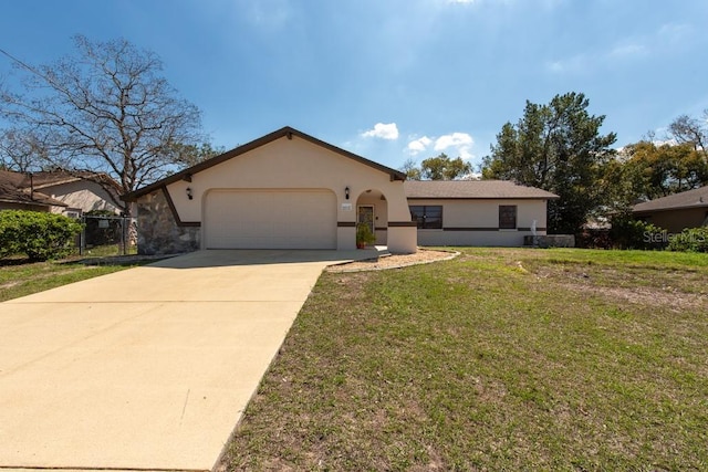 view of front of house featuring a garage, driveway, a front lawn, and stucco siding