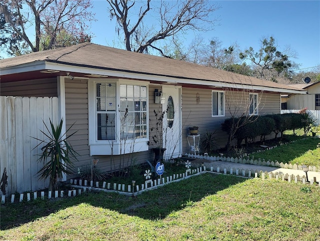 view of front of property with a front lawn and fence