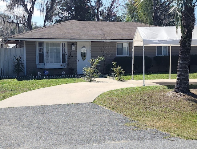 single story home with driveway and a front yard