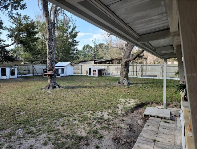 6328 W Park Dr, Homosassa, FL 34446 - view of yard with a fenced backyard, a storage unit, and an outdoor structure