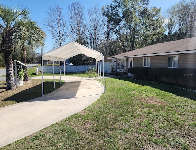 6328 W Park Dr, Homosassa, FL 34446 - view of yard with a detached carport, fence, and concrete driveway