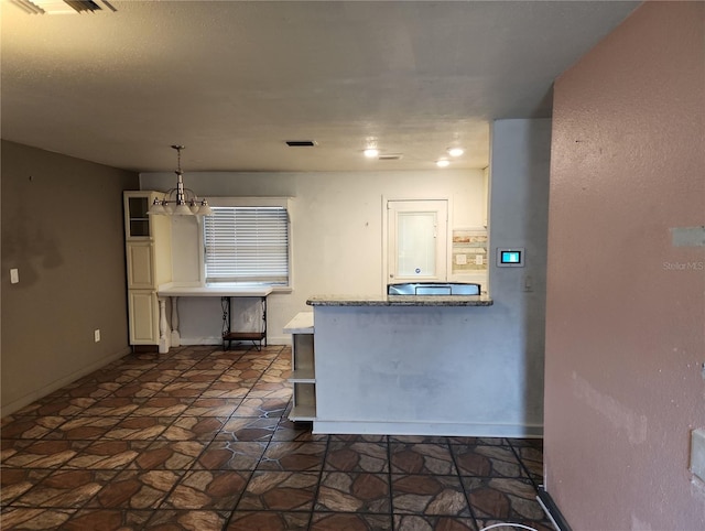 6328 W Park Dr, Homosassa, FL 34446 - kitchen featuring visible vents, baseboards, an inviting chandelier, and decorative light fixtures
