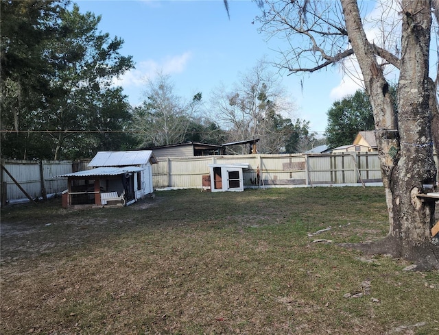 6328 W Park Dr, Homosassa, FL 34446 - view of yard with exterior structure, a fenced backyard, and an outdoor structure