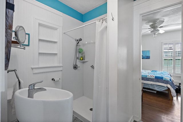 bathroom featuring hardwood / wood-style floors, a textured ceiling, ceiling fan, and walk in shower