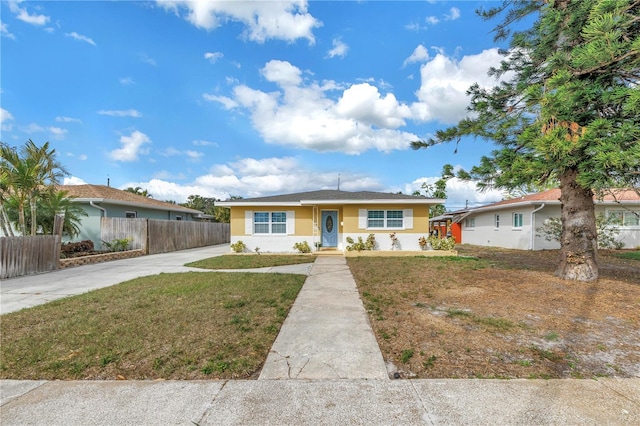 ranch-style home featuring a front yard