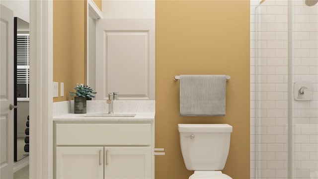 bathroom featuring vanity, a shower with shower door, and toilet