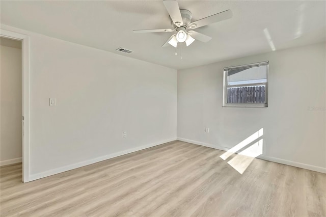 empty room with light hardwood / wood-style floors and ceiling fan