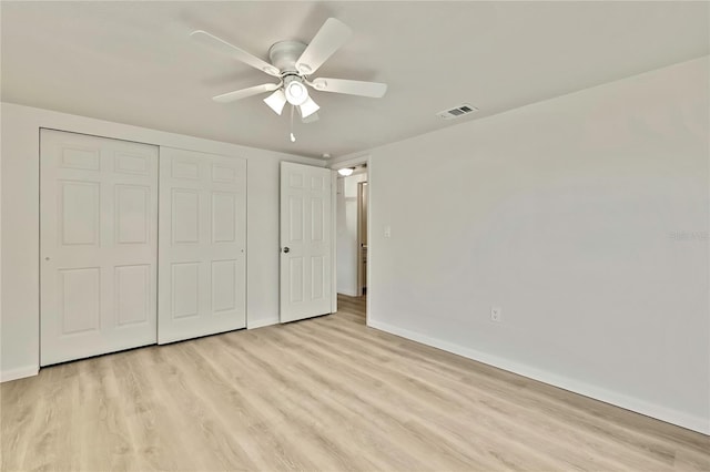 unfurnished bedroom featuring ceiling fan, light hardwood / wood-style floors, and a closet