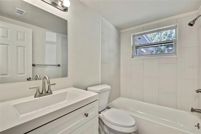 full bathroom with tiled shower / bath, vanity, and toilet