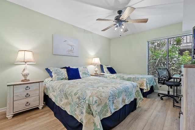 bedroom featuring light wood-type flooring, ceiling fan, and baseboards