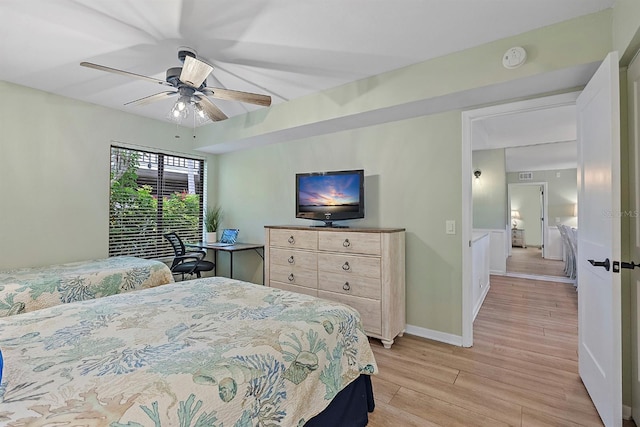 bedroom with a ceiling fan, light wood-style flooring, and baseboards