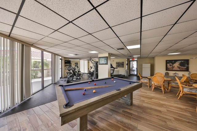 playroom with a paneled ceiling, visible vents, and wood finished floors