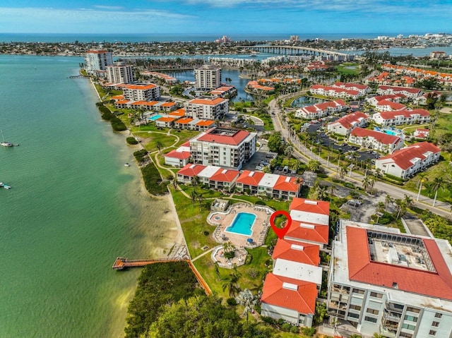 birds eye view of property featuring a water view and a city view