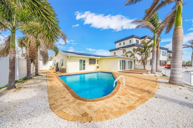 view of swimming pool with cooling unit and a patio area