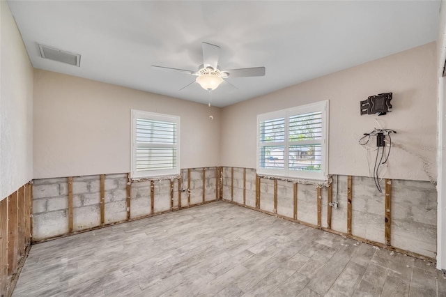 empty room with wood-type flooring and ceiling fan