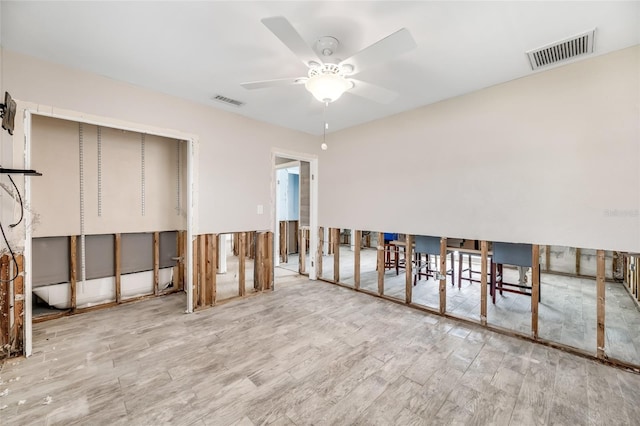 empty room featuring ceiling fan and light hardwood / wood-style flooring