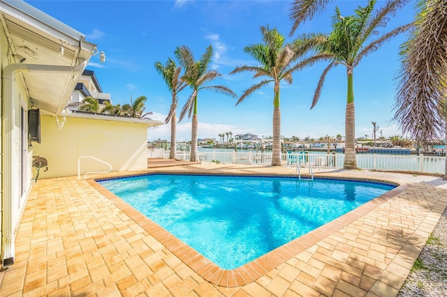 view of swimming pool featuring a fenced in pool, a patio, a water view, and a fenced backyard