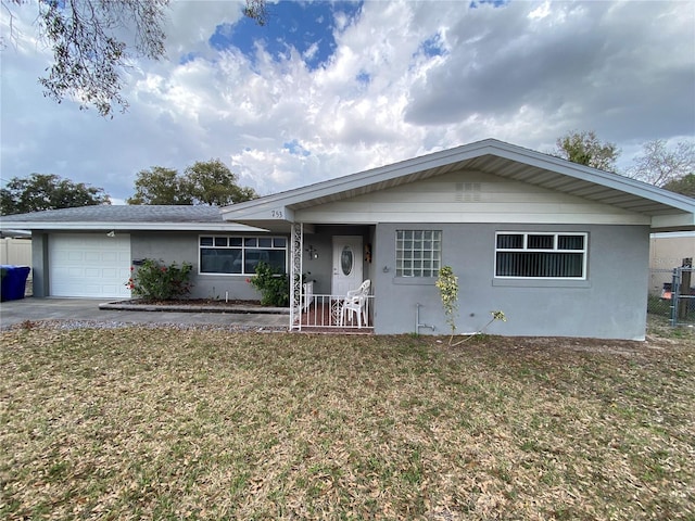 ranch-style house featuring a garage and a front yard