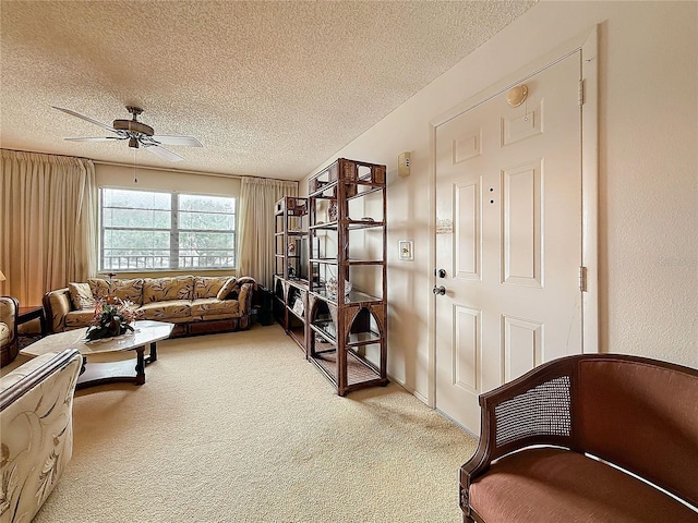 8174 Terrace Garden Dr N Unit 307, Saint Petersburg, FL 33709 - sitting room featuring ceiling fan, carpet flooring, and a textured ceiling