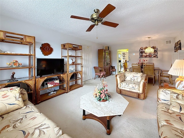 8174 Terrace Garden Dr N Unit 307, Saint Petersburg, FL 33709 - living room featuring ceiling fan, light carpet, and a textured ceiling