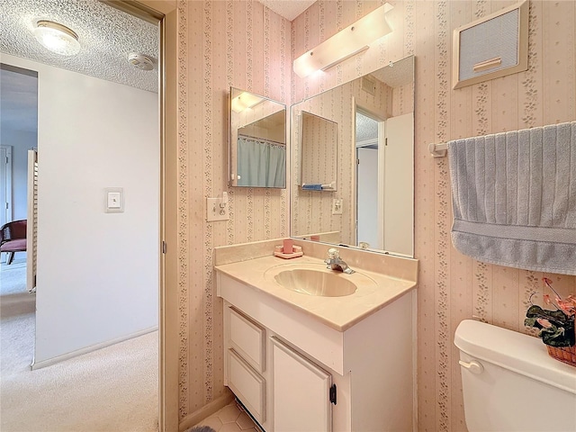 8174 Terrace Garden Dr N Unit 307, Saint Petersburg, FL 33709 - bathroom featuring vanity, a textured ceiling, and toilet