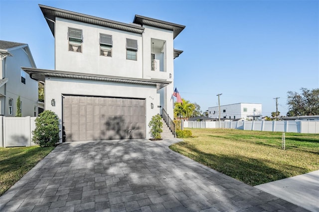 view of front of property with a garage and a front lawn