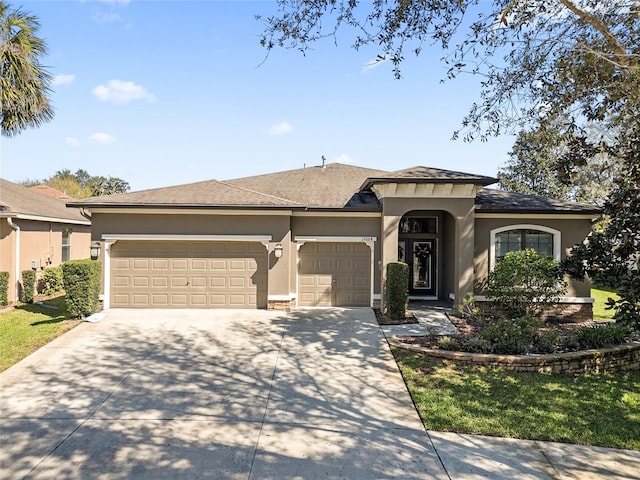 view of front of property featuring driveway, an attached garage, and stucco siding