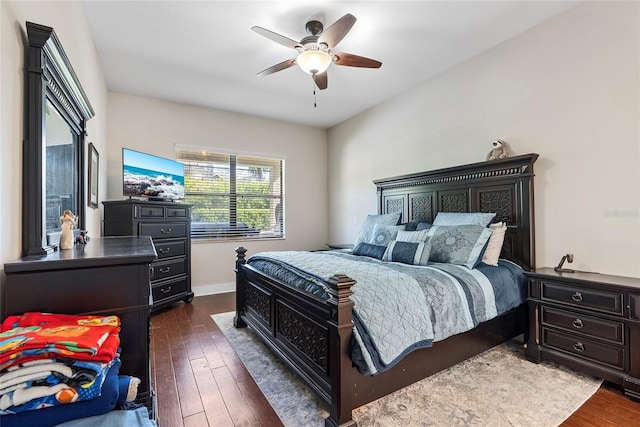 bedroom featuring ceiling fan, baseboards, and dark wood-style flooring