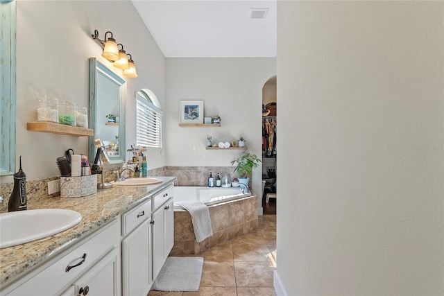 full bath featuring double vanity, tile patterned flooring, a sink, and visible vents