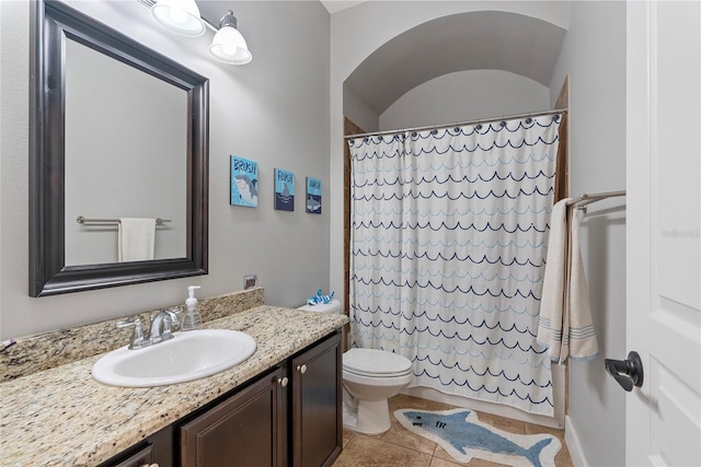 bathroom with toilet, tile patterned flooring, and vanity