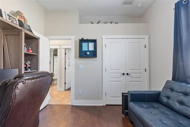 office with baseboards, visible vents, and dark wood-style flooring