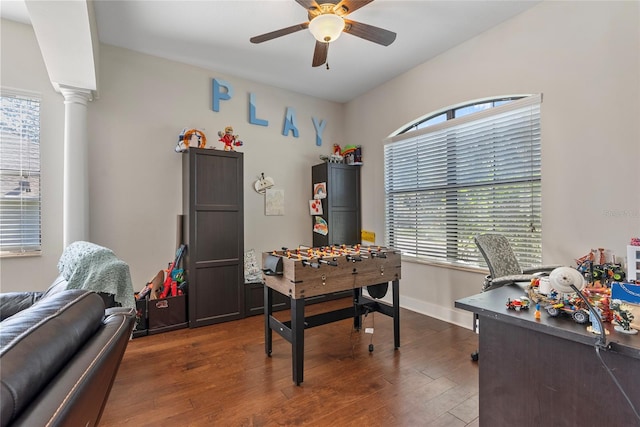 office space featuring a ceiling fan, baseboards, ornate columns, and wood finished floors