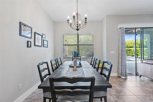 dining space featuring a chandelier, light tile patterned flooring, and baseboards