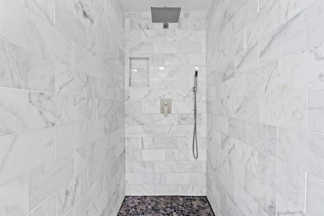 full bath with a tile shower