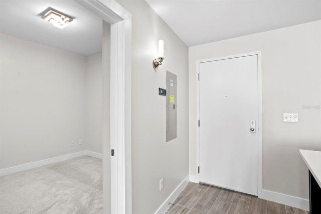 foyer entrance featuring wood finished floors and baseboards
