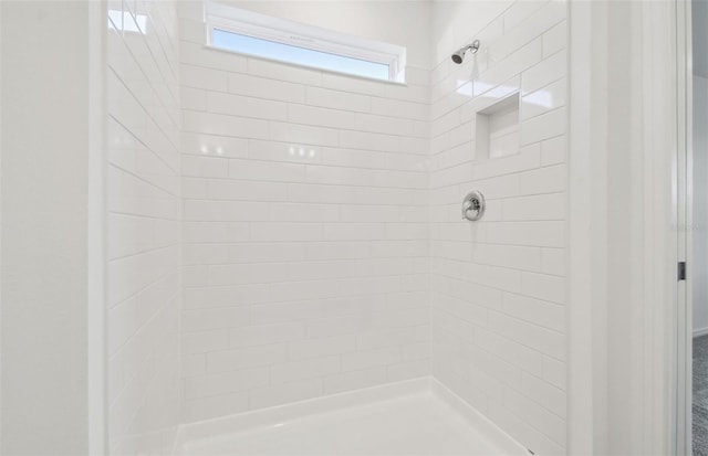 full bathroom with a tile shower