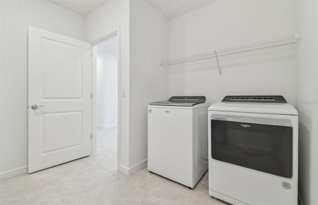 laundry area with washer and dryer, laundry area, and baseboards