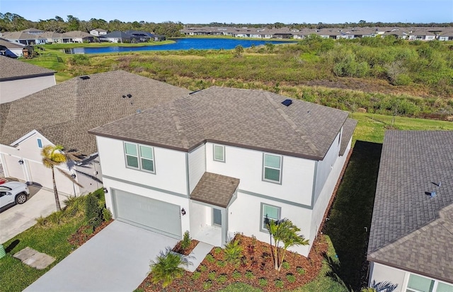 birds eye view of property with a water view and a residential view