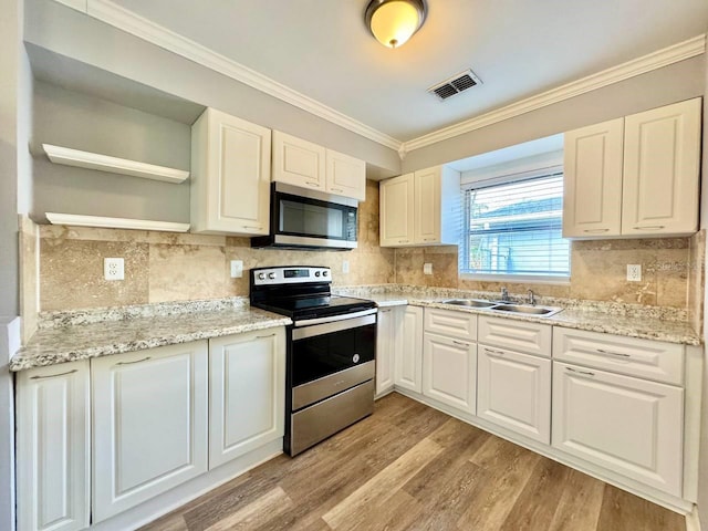 kitchen featuring sink, light hardwood / wood-style flooring, white cabinetry, stainless steel appliances, and ornamental molding