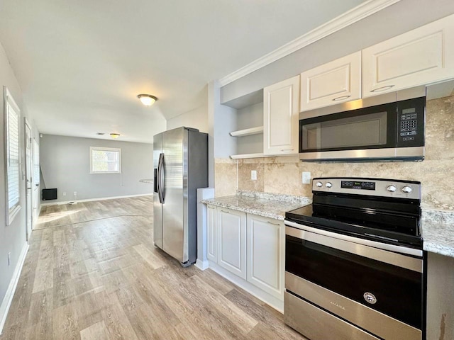 kitchen featuring stainless steel appliances, white cabinets, and light wood-type flooring